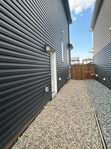 a side view of a house with a garage at Lizzy cozy Basement suite in Airdrie