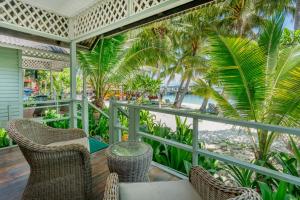 a balcony with chairs and a view of the beach at Rawa Island Resort in Mersing