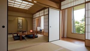 a room with a table and a dining room at Kiyosato Kogen Resort in Hokuto