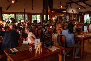 a group of people sitting at tables in a restaurant at Taha Tai in Hanga Roa +146 photos