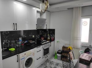 a kitchen with a sink and a washing machine at Hostel in Yakuplu