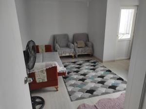 a living room with a couch and a rug at Hostel in Yakuplu