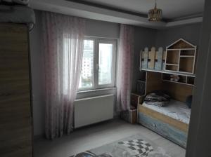a small bedroom with a bed and a window at Hostel in Yakuplu
