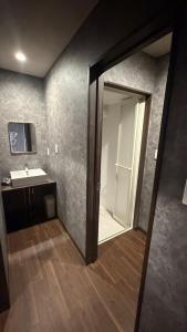 a bathroom with a sink and a mirror at hostel大黒屋 in Miyoshi +83 photos