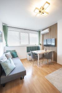 a living room with a couch and a table at Boho Spa Apartments with Sauna in Sofia
