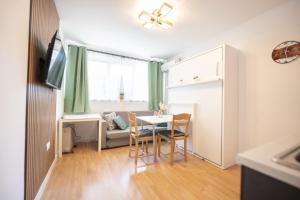 a small living room with a table and chairs at Boho Spa Apartments with Sauna in Sofia +7 photos