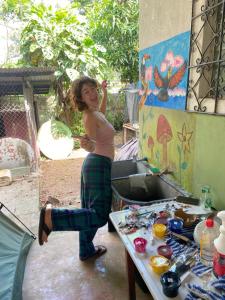 a woman is standing in front of a sink at La casa de ito la chorrera in La Chorrera
