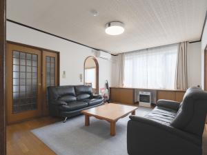 a living room with two chairs and a coffee table at Slow Toya in Lake Toya
