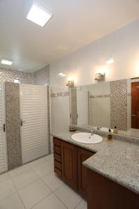 a bathroom with a sink and a mirror at Na Casa Hostel in Manaus +134 photos