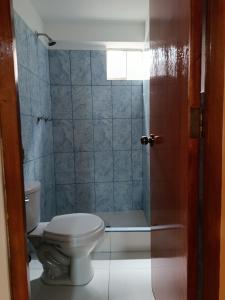 a bathroom with a toilet and a shower at Allin Samay in Ayacucho