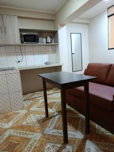 a living room with a table and a couch at Allin Samay in Ayacucho
