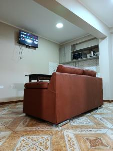 a brown couch sitting in a living room at Allin Samay in Ayacucho