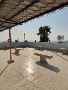 a group of benches sitting on a patio at Sky n Valley in Bāndarban
