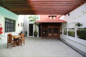 a patio of a house with a table and chairs at Na Casa Hostel in Manaus