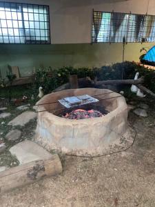 a large stone fire pit in a building at La casa de ito la chorrera in La Chorrera