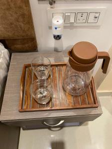 a tray with two glasses on top of a table at Rudravasa Inn in Varanasi