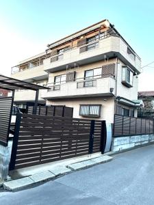 a building with a fence in front of it at 清場Kiyoba in Kawaguchi