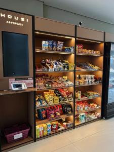 a food section of a store with a tv in it at Art Studio Mare Loft in Salvador
