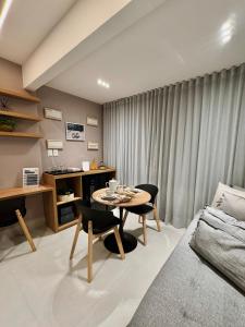a living room with a table and a couch at Art Studio Mare Loft in Salvador