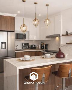 a kitchen with a large island in a kitchen at Apartamento con Piscina in Las Victorias