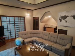 a living room with a couch and a table at 民泊よこてこよ in Yokote