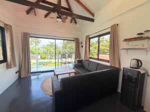 a living room with a couch and a large window at New Apartment Santa Fe in General Luna