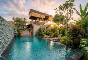 a swimming pool in the backyard of a house with a villa at Sari Murni in Ubud +20 photos