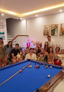 a group of people posing next to a pool table at Hotel Dell' Alba in Phú Quốc