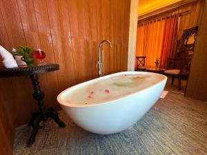 a white bath tub sitting in a room at Kingswood Tea Factory in Ramboda +28 photos