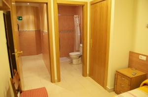 a bathroom with a shower and a toilet in a room at Pension Zorroza 1 in Bilbao