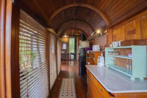 a kitchen with wooden walls and an arched ceiling at Silk Pavilions Glamping in Mount Burrell