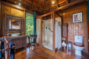 a bathroom with a shower and a toilet in a room at Silk Pavilions Glamping in Mount Burrell