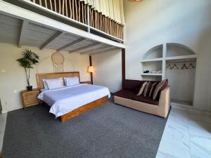 a bedroom with a large bed and a couch at Batur Panorama in Kintamani
