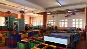 a large room filled with lots of colorful boxes at Kingswood Tea Factory in Ramboda