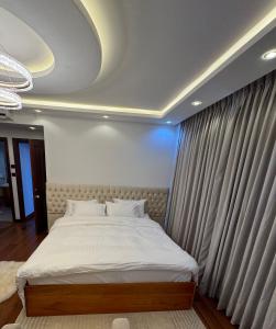 a bedroom with a large bed with curtains at The Crescat Suite by Cinnamon Grand in Colombo +30 photos