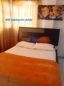 a bedroom with a large bed with at Hotel Avenida El Bosque a 2 cuadras de la clínica foscal y cardiovascular,HIC,Unab in Floridablanca
