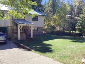 a house with a yard with a driveway at Durango Colorado Four Bedroom Two Bathroom Home in Durango