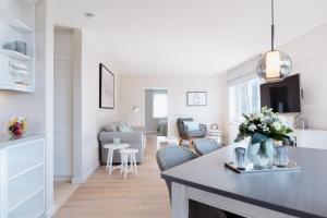 a kitchen and living room with a table and chairs at Anker Mal am Hafen in Husum