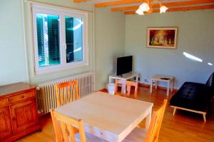 a living room with a table and a television at Big Villa in Sainte-croix in Sainte-Croix