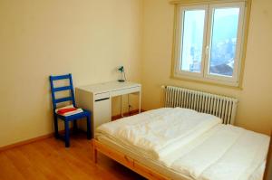 a bedroom with a bed and a desk and a chair at Big Villa in Sainte-croix in Sainte-Croix +17 photos