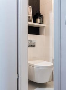 La salle de bains est pourvue de toilettes blanches. dans l'établissement Marszałkowska Apartament 138, à Varsovie