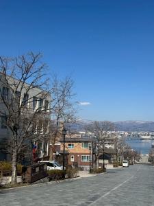 an empty street in a town with a body of water at 函館 FabulousHouse 一棟貸し最大17名 in Hakodate
