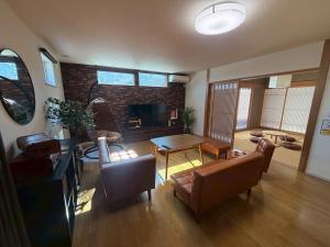 a living room with a couch and a table at 函館 FabulousHouse 一棟貸し最大17名 in Hakodate