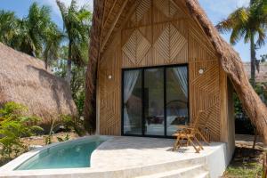 a house with a pool in front of it at Corales de Isla Fuerte in Puerto Limón
