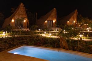 a resort with a swimming pool at night at Corales de Isla Fuerte in Puerto Limón