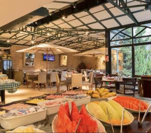 a buffet of food on display in a restaurant at Flat Hotel de luxo em Moema, São Paulo in São Paulo