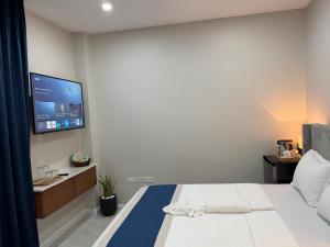 a bedroom with a bed with a tv on the wall at Sanrai in Gros Islet