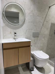 a bathroom with a sink and a toilet and a mirror at Sanrai in Gros Islet