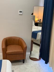 a mirror in a room with a chair and a bed at Sanrai in Gros Islet