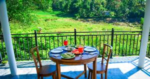 a table with a plate of food on a porch at Ella River Breeze Homestay in Ella +70 photos